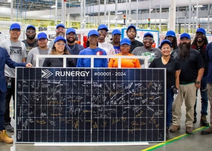Runergy employees with the first solar panel produced at the Alabama plant, US