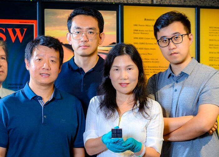 UNSW's Professor Xiaojing Hao (middle right) holding the record-breaking kesterite solar cell. Image: UNSW.